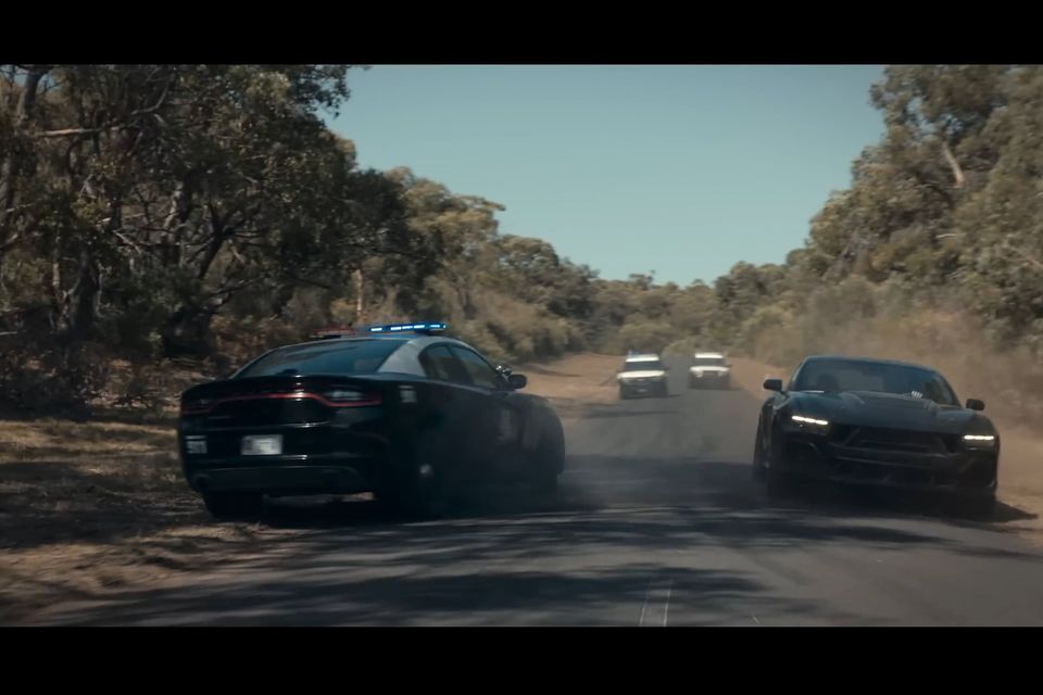 Like a scene from a NASCAR race, one of the hero Mustangs takes out the Dodge Charger interceptor...